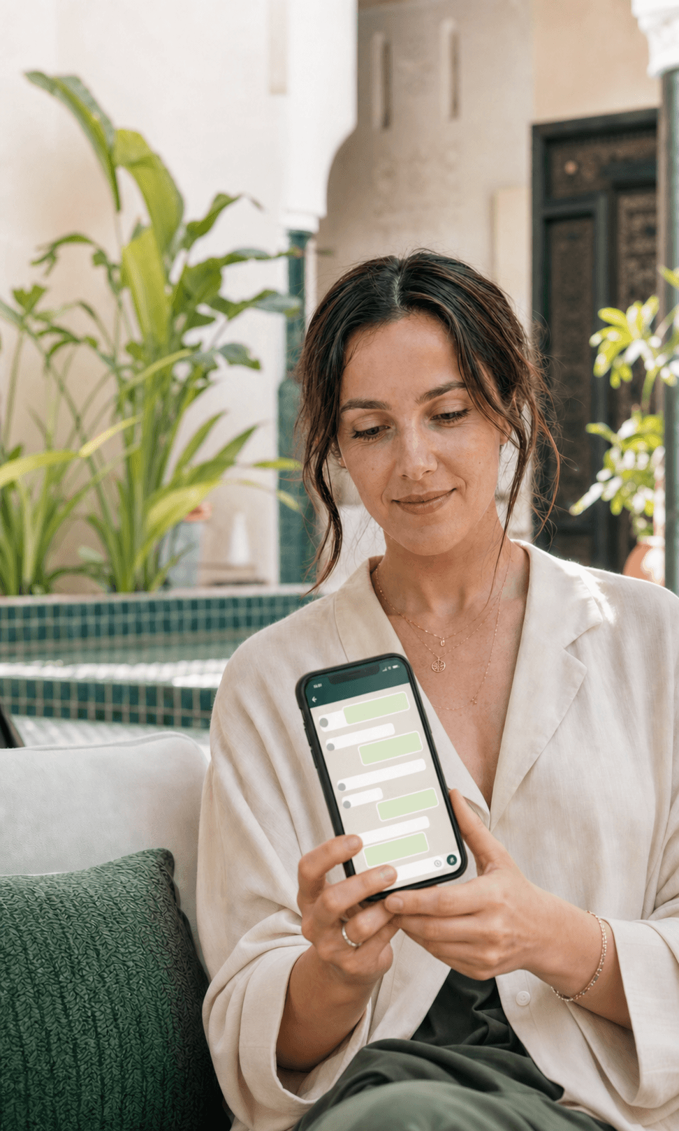 A guest showing a WhatsApp-style conversation on her phone